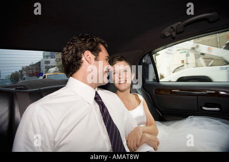 A bride and groom in a car Stock Photo