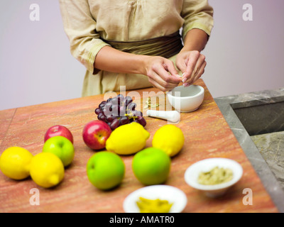 Woman in kitchen with fruits, mid-section Stock Photo