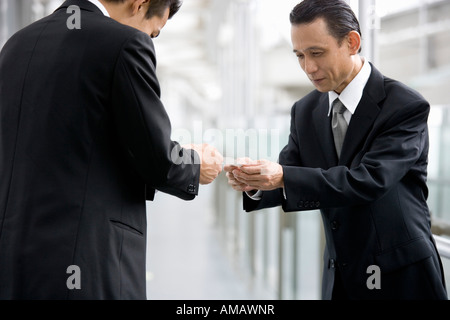 Two businessmen exchanging business cards Stock Photo