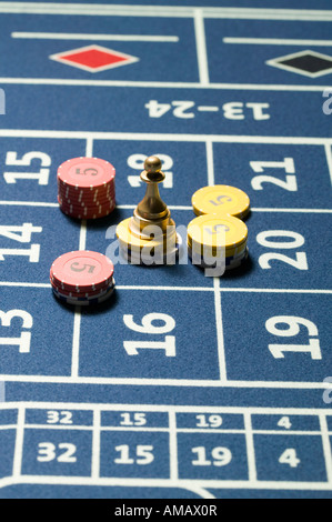 Stacks of gambling chips with roulette win marker on roulette table Stock Photo