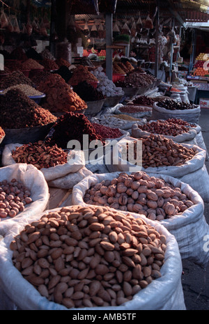 Sacs of nuts and piles of dried fruit on sale on a market stand in Baku Azerbaijan 1999 Stock Photo