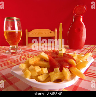 dish with chips and ketchup and beer glas on a table Stock Photo