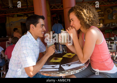 young couple having drinks at outdoor cafe Stock Photo