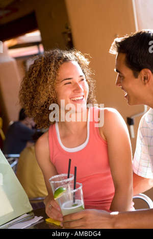 young couple having drinks at outdoor cafe Stock Photo