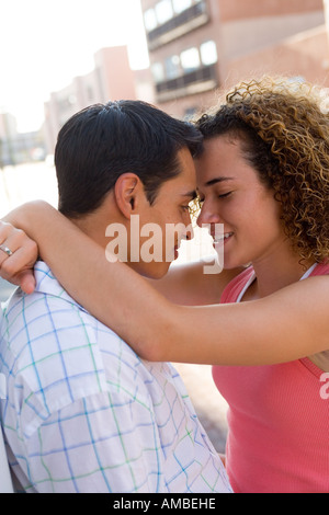 young  amorous couple embracing on the street Stock Photo