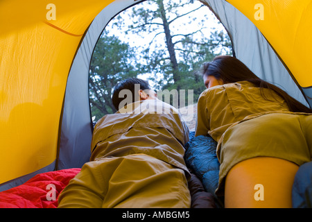 rear view of young couple lying in tent Stock Photo