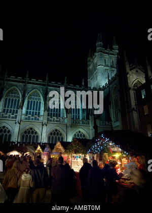 Bath Christmas market, illuminated stalls line the streets beneath the impressive Bath Abbey. Picture by Jim Holden. Stock Photo