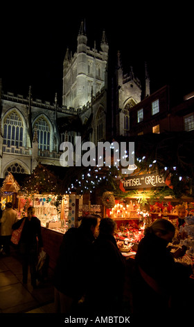 Bath Christmas market, illuminated stalls line the streets beneath the impressive Bath Abbey. Picture by Jim Holden. Stock Photo