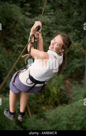 Woman on a zip line at The Gibbon Experience near Huay Xai on the Mekong river near the Laos Thai border Stock Photo