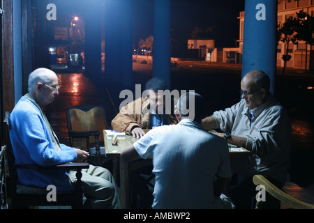 Cuba Cienfuegos Elderly men playing domino at night Domino is extremly popular in Cuba Stock Photo