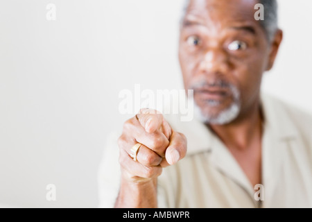 Portrait of a middle-aged man pointing Stock Photo