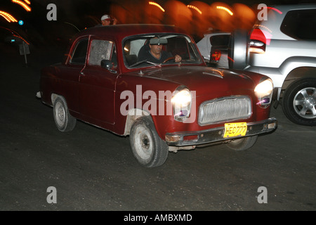 Cuba Havana nightscene a classic car driving through the night streets Stock Photo