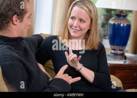 View of a young couple talking in sign language. Stock Photo