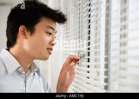 A man looking out from a window. Stock Photo
