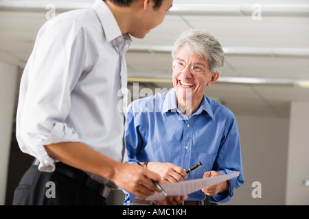 Two business executives gossiping. Stock Photo