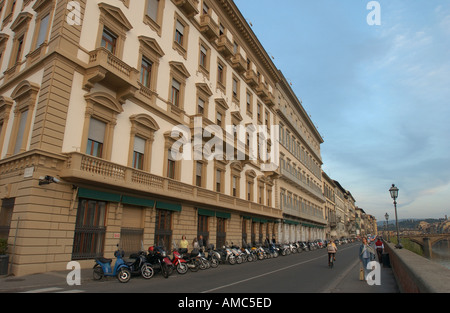Street of Florence Italy Arno River cloud clouds cyclist balconies bridges bike bicycles building arch arches architecture Stock Photo