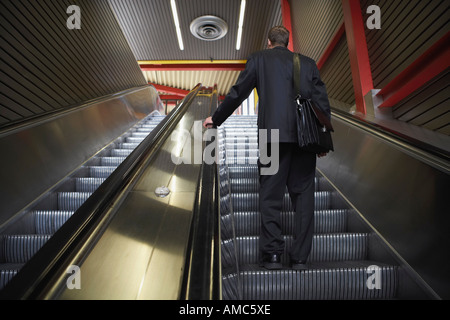 Businessman on Escalator Stock Photo