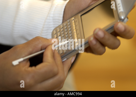 Latino Woman using a PDA organiser organizer Stock Photo