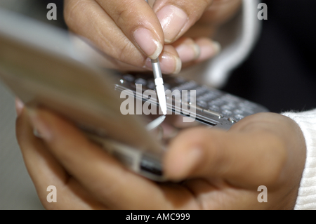 Latino Woman using a PDA organiser organizer Stock Photo