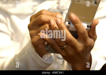 Latino Woman using a PDA organiser organizer Stock Photo