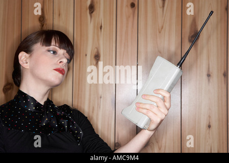 Woman Looking at Old Cellular Phone Stock Photo