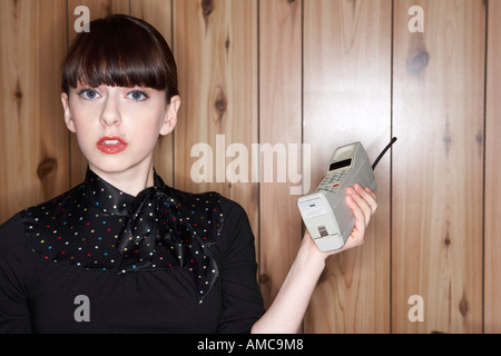 Portrait of Woman With Old Fashioned Cellular Phone Stock Photo