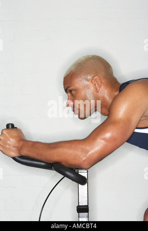 Man on Exercise Bicycle Stock Photo