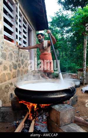 Professional cook preparing sweet dish known as payasam usually served as dessert for traditional wedding feasts in Kerala Stock Photo