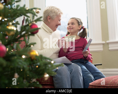 Girl Receiving Christmas Money from Grandmother Stock Photo