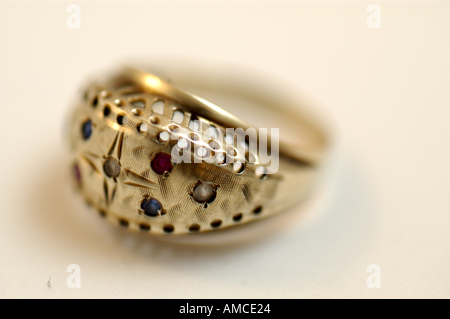 A close up of a gold ring encrusted with several types of semiprecious stones. Stock Photo