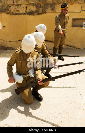 Fort Rinella malta Victorian soldiers rifle weapons  uniform khaki defence defending armed dangerous shooting reloading Stock Photo