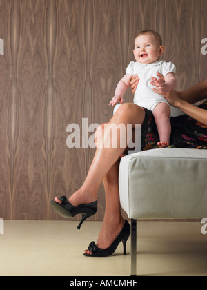 Baby Sitting on Mother's Lap Stock Photo
