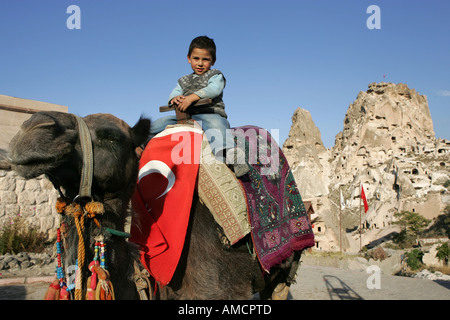 TUR, Turkey, Cappadocia, Uchisar, 17.10.2005: Boy on a camel, waiting for tourists. Stock Photo