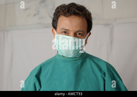Doctor surgeon wearing face mask and  green operation theater gown, MR#637 Stock Photo