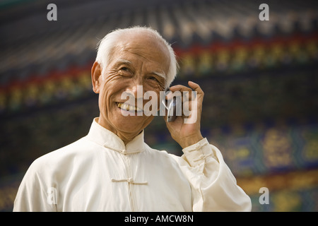 Man talking on cell phone outdoors smiling Stock Photo