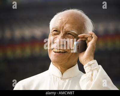 Man talking on cell phone outdoors smiling Stock Photo
