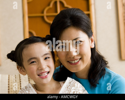 Mother and daughter embracing and smiling Stock Photo