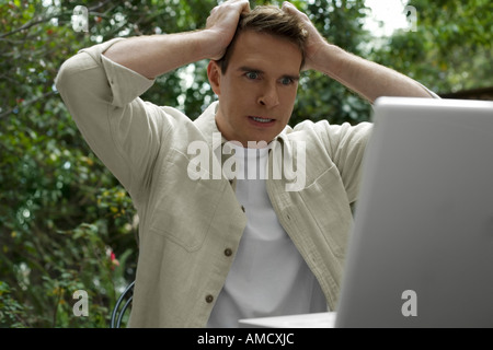 Man Sitting Outside With Laptop Computer Stock Photo
