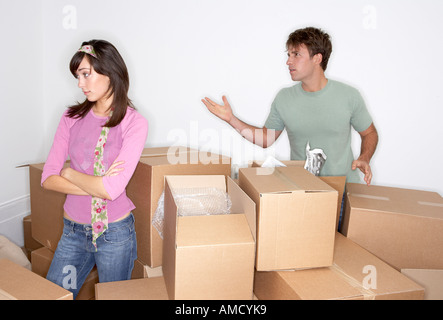 Couple Arguing amongst Boxes Stock Photo