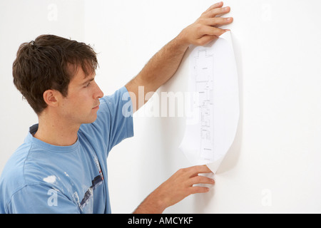 Man Looking at Building Plans Stock Photo