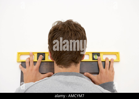 Man Hanging Picture Stock Photo