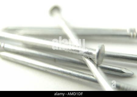 A close-up of a pile of nails on a white background. Stock Photo