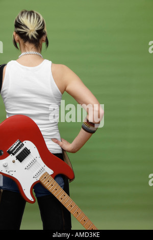 Back View of Woman with Electric Guitar Stock Photo