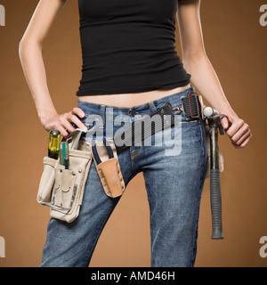 Mid section view of woman with tool belt Stock Photo