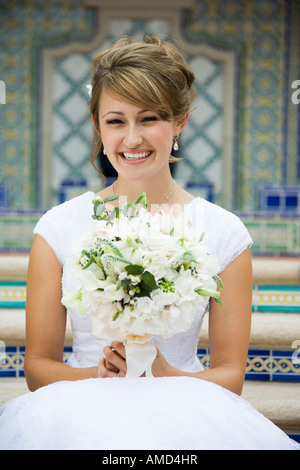 Portrait of bride sitting on steps Stock Photo - Alamy