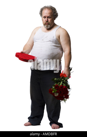 Disheveled man with red roses and heart box frowning Stock Photo