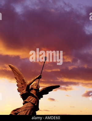 sunset angel statue with trumpet Stock Photo