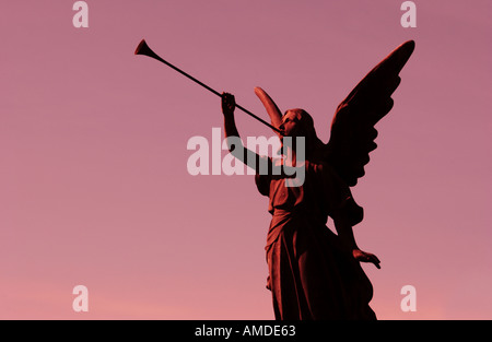 sunset angel statue with trumpet Stock Photo