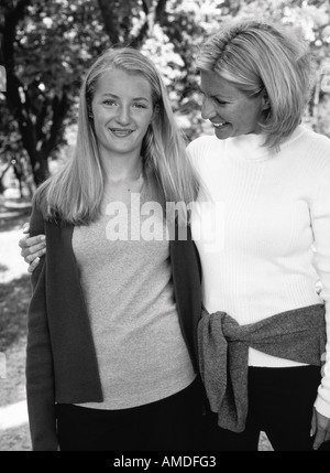 Portrait of Mother and Daughter Standing Outdoors Stock Photo