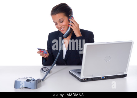 Office worker reading credit card Stock Photo
